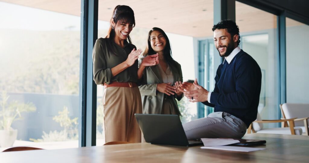 Business, people and applause with laptop in office for good news, celebration and budget approval.