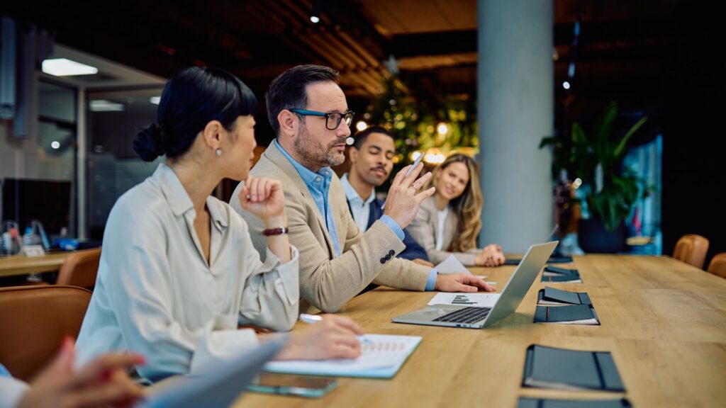 Business professionals engaging in a meeting, discussing strategy and ideas,