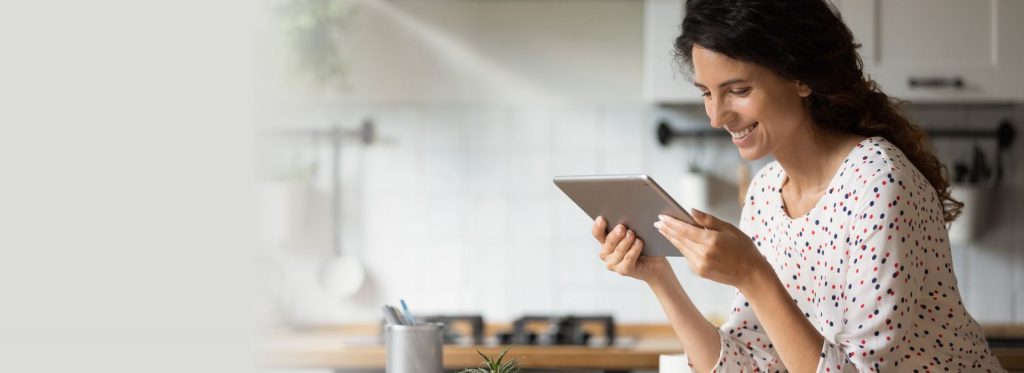 Women smiling while using tablet