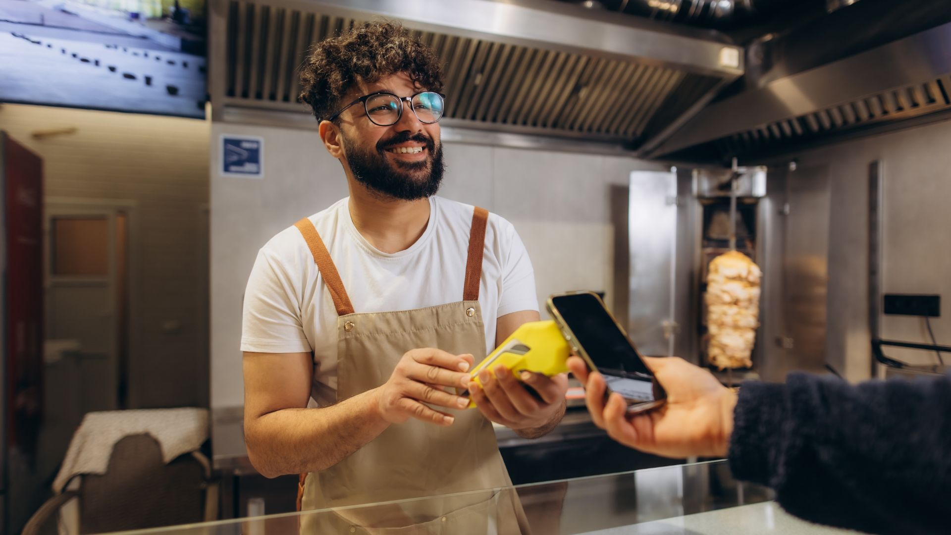 Small business owner accepting mobile pay