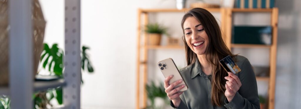 Woman holding her phone and credit card