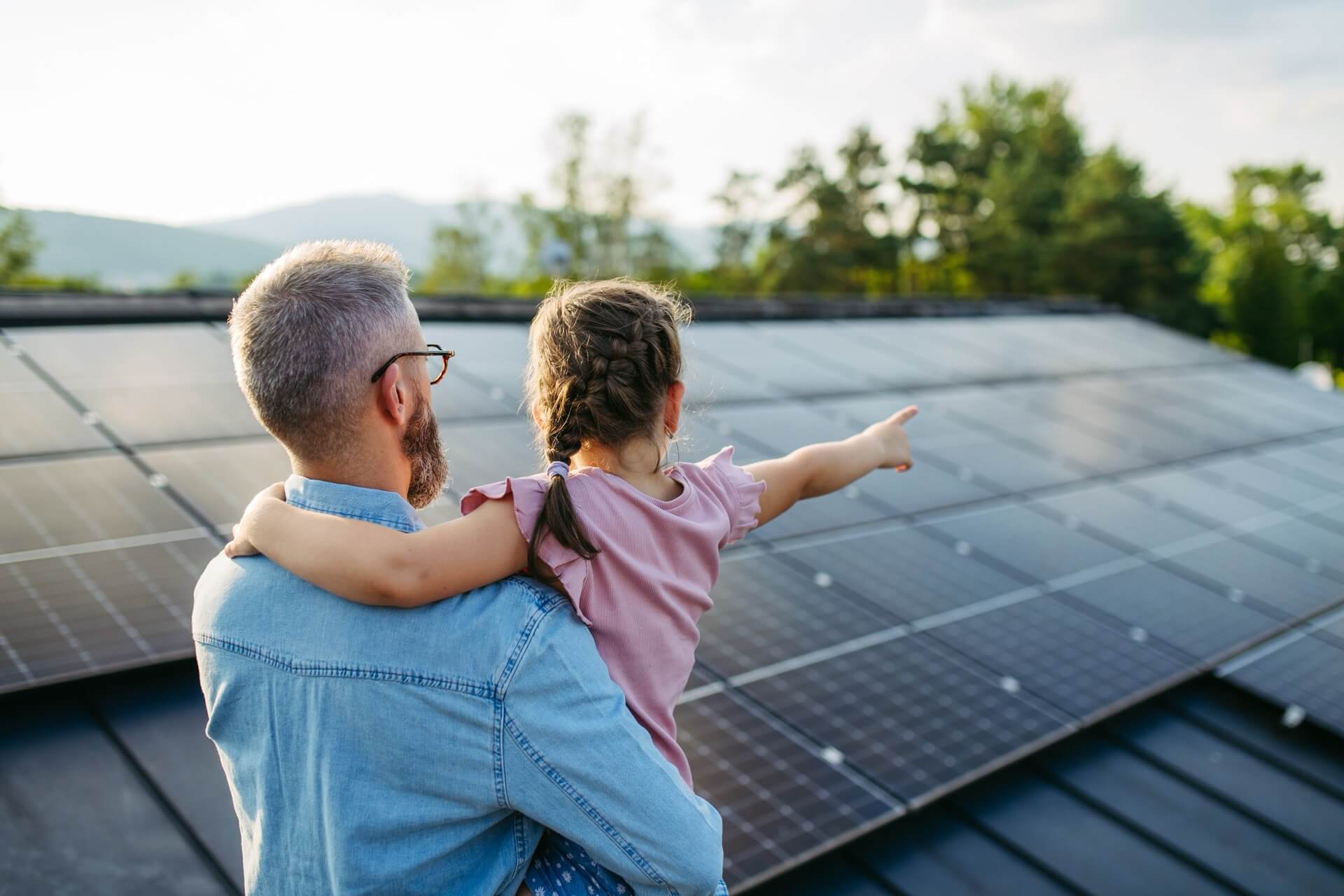 a man and girl pointing at solar panels