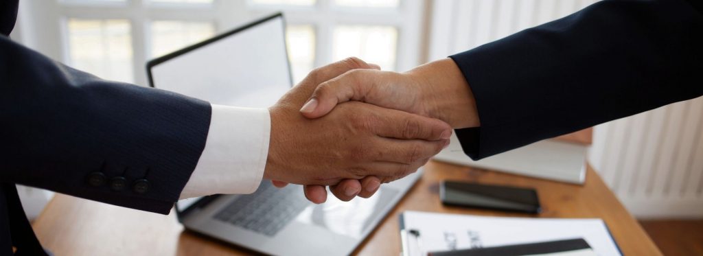 Two people are shaking hands.