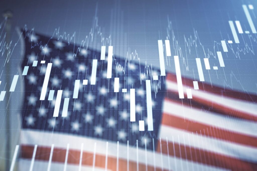 Stock market candlestick chart overlaid on a blurred American flag background.