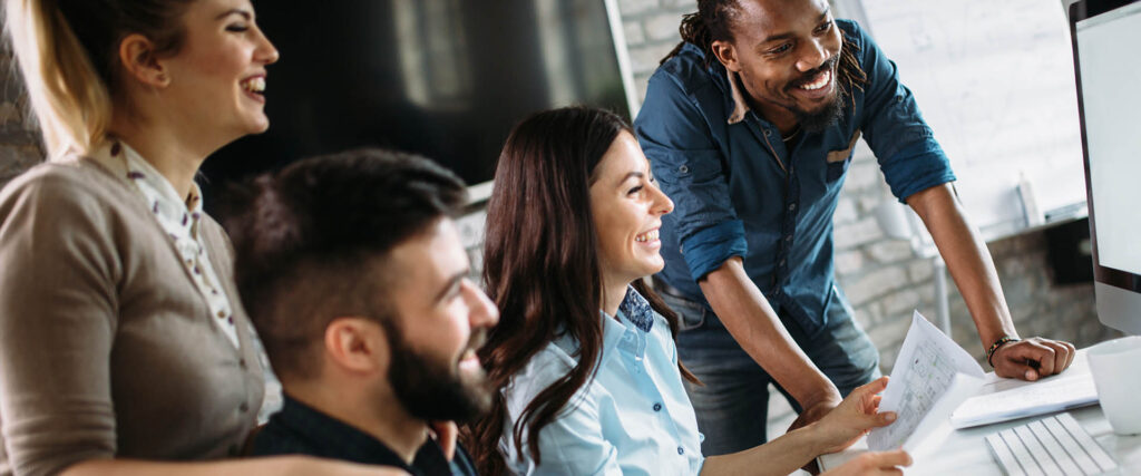 Group of young people at a desk in a modern workplace