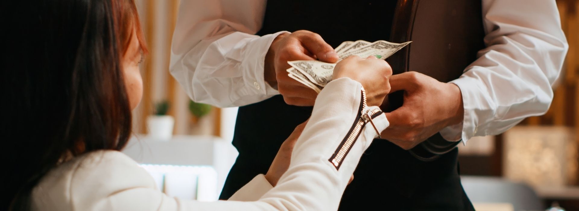Woman tipping waiter