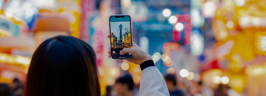 Person taking a photo of a building on their phone