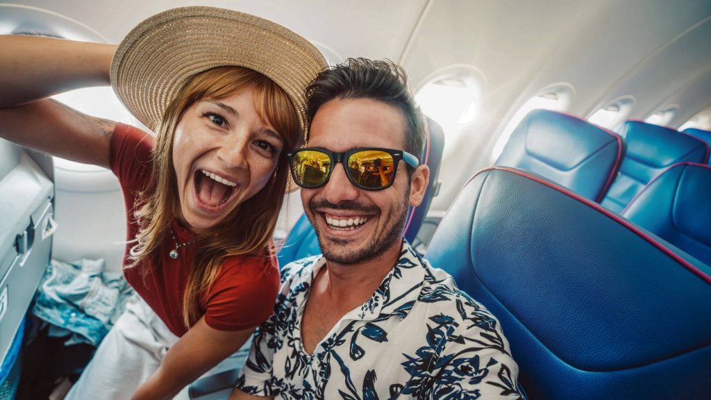 Couple taking selfie on a plane.
