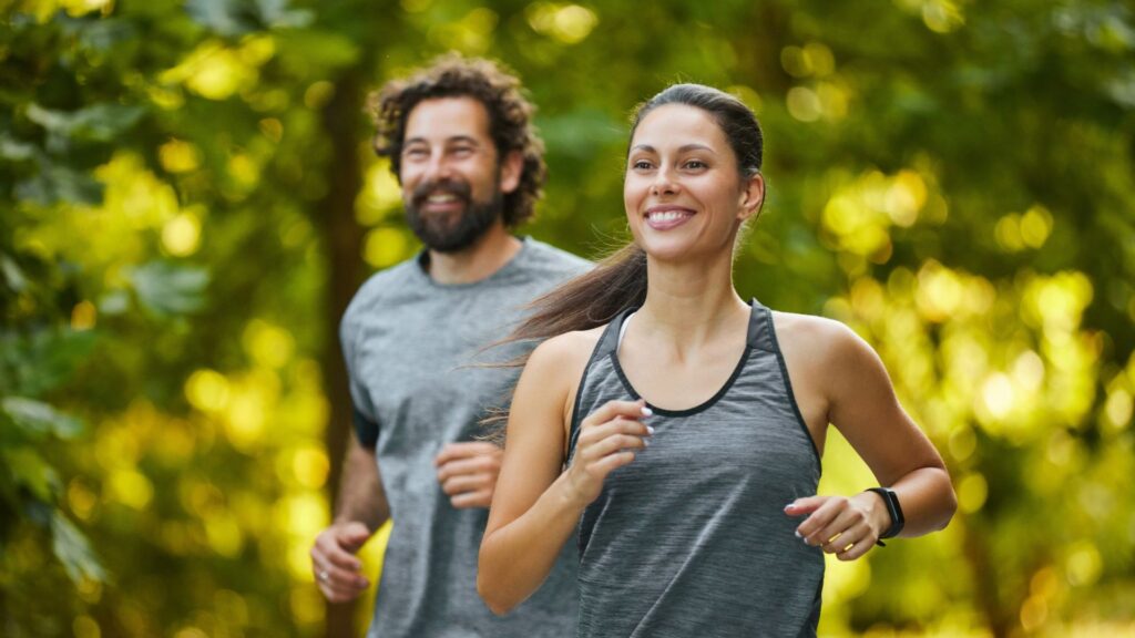 In a serene park, a man and woman run together