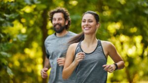 In a serene park, a man and woman run together