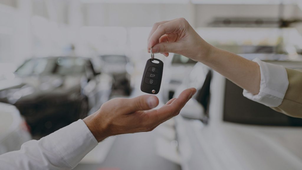 Person receiving car keys.