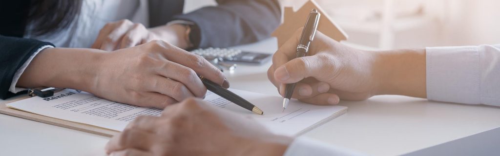 business owner signing a sale contract with solicitor