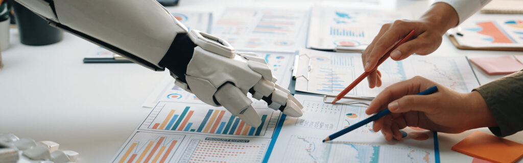 robotic arm and human hands collaborating on data-driven graphs and charts in a modern office setting