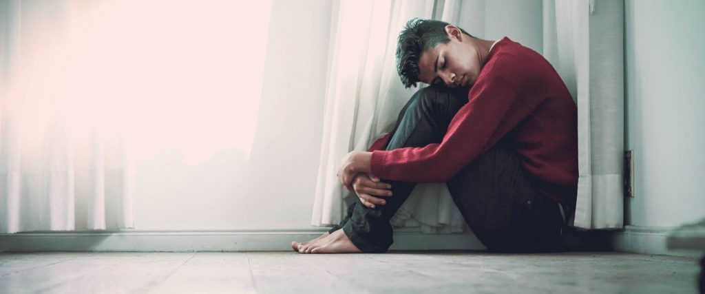 young man sitting on floor