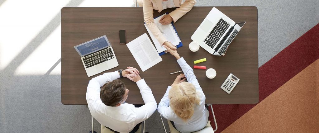 couple discussing investments with a financial consultant