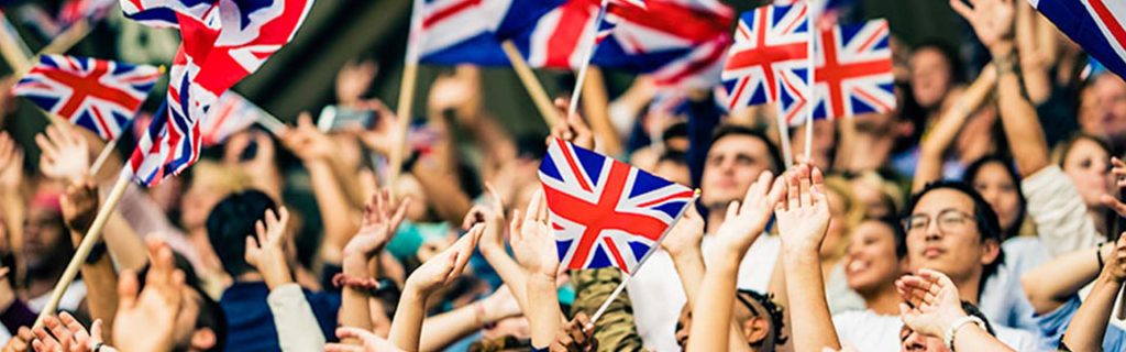 People cheering with the union jack flag