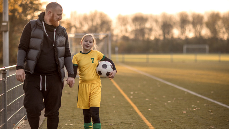 father daugther on soccer field