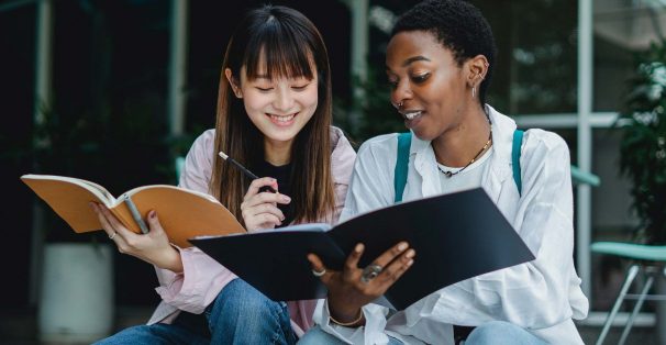 two friends comparing school work