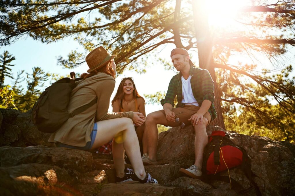 Relax, hiking and talking with friends in nature for mountain explore, adventure and sunshine
