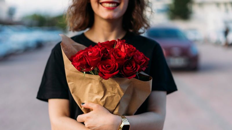 hugging bouquet of flowers