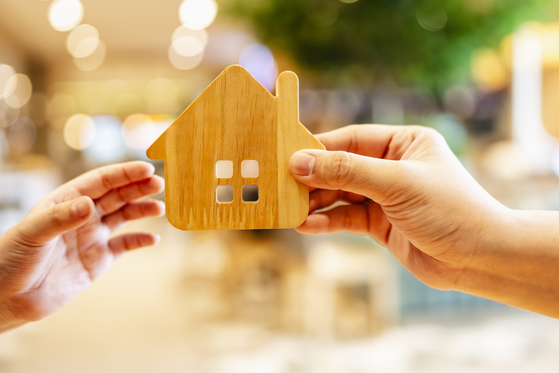 Real estate agent or parent giving house model to child