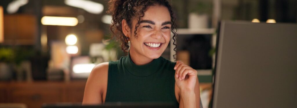 woman happily looking at computer