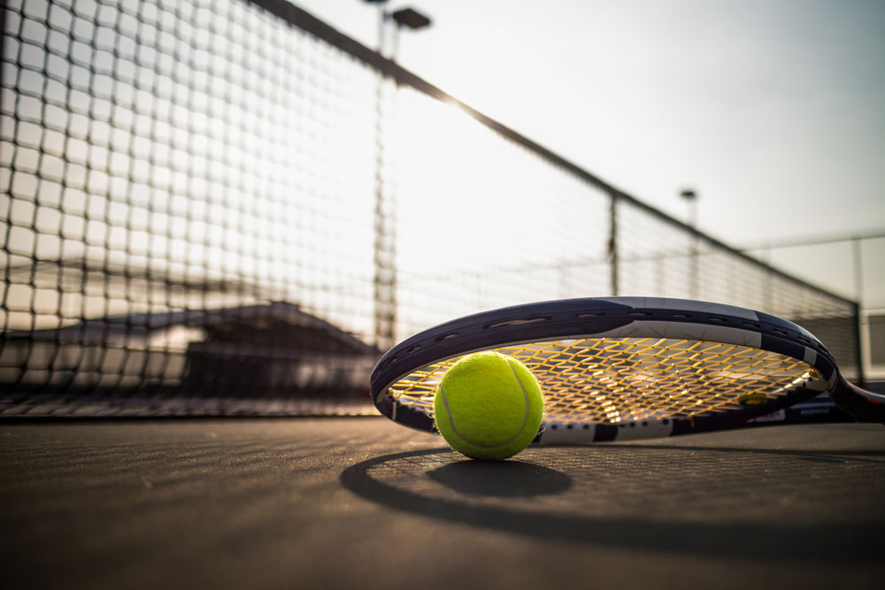 Tennis ball racket on hard court